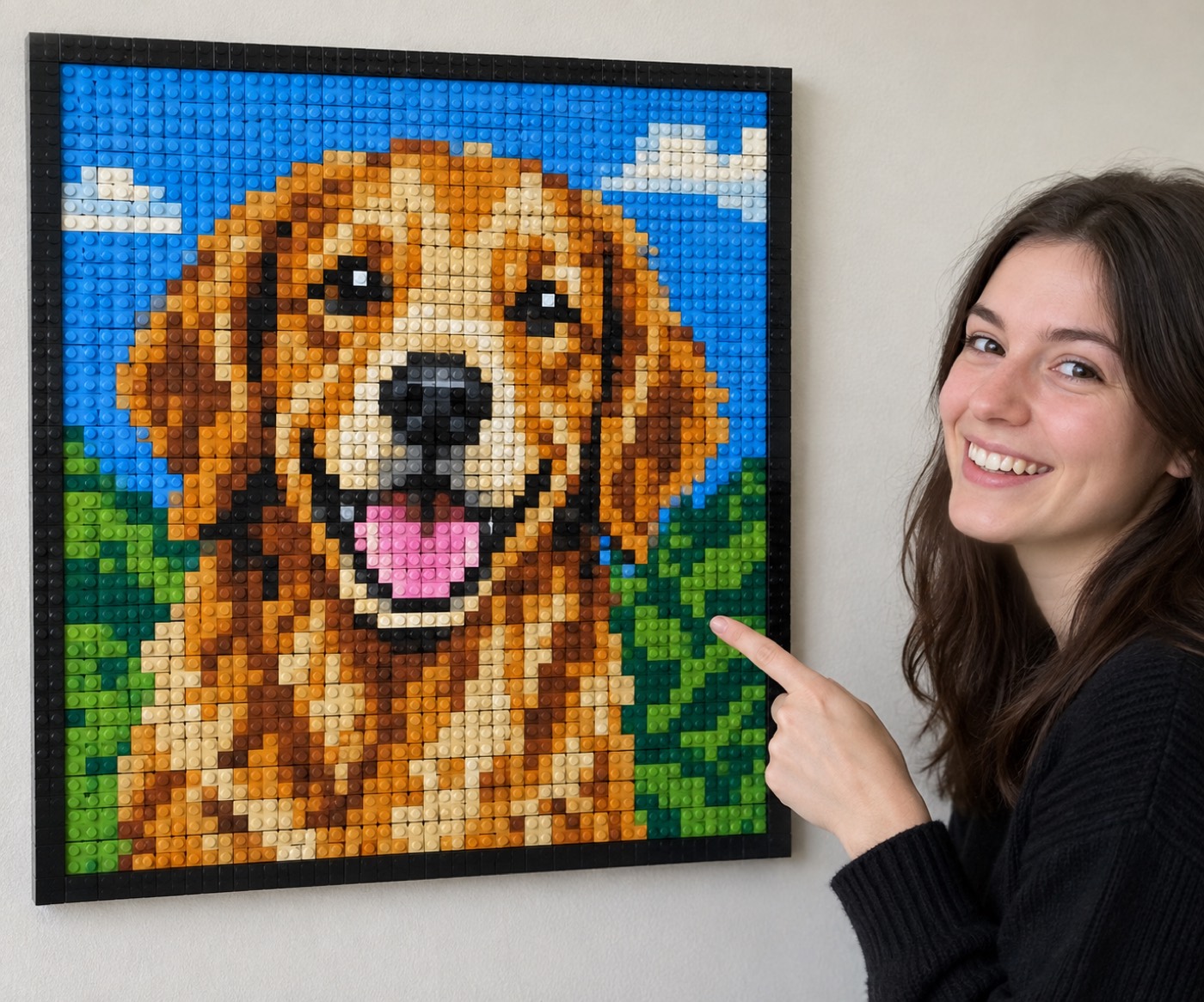 Frau zeigt auf ein fertiges Klemmbaustein-Mosaik mit Hundemotiv an der Wand